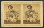 View of a photograph surrounded by a memorial wreath.