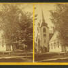 View of a church, obscured by trees.