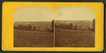 View of Barre in the distance with rock fence in foreground.