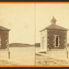 Small building on the edge of a lake, possibly a gatehouse for a water system.
