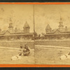 The railroad station, man with dog in foreground.