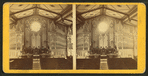 Interior of a church showing the altar, a large organ, and painted ceiling.