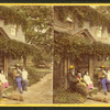 Group of people sitting in front of a house.