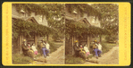 Group of people sitting in front of a house.