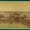 View of town with trees in foreground.