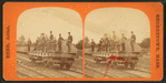 Men in uniform on railroad flat car with fire engine(?).