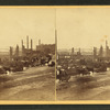 Buildings along the Merrimack River totally destroyed except for the chimneys.