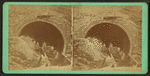 Workers at mouth of tunnel.