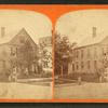 View of a home, people posing on the steps.