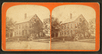 View of a home, people posing on the steps.