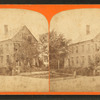View of a home, people posing on the steps.