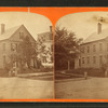 View of a home, people posing on the steps.