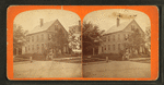 View of a home, people posing on the steps.