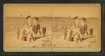 Group on a beach, some with umbrellas.