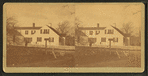 Unidentified home at a cross roads surrounded by a picket fence.