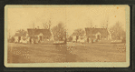 Unidentified home at a cross roads surrounded by a picket fence.