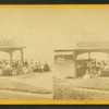 Group of people in front of the ice cream stand.