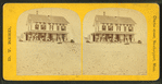 Group of people on the porch of a house emblazzed with the words "Our House".