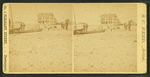 Men standing near boats on the beach, Our House in the background.