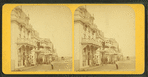 View of people in front of cottages.