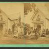 People posed in front of a cottage.