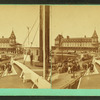 View of a pier from the deck of a boat, Sea View House in background.