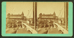 View of a pier from the deck of a boat, Sea View House in background.