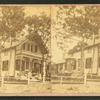 People on the porch of a cottage.