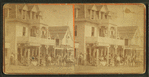 Gathering in front of a commercial building.