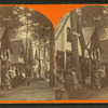 People in front of cottages.