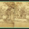 People in front of cottages.