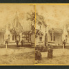 People in front of a cottage decorated with bunting.