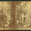 Group gathered in front of a cottage.