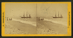 People on the shore looking at a ship.