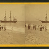 People on the shore looking at a ship.