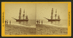 People on the shore looking at a ship.