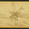Men working on ship hove down for repairs.