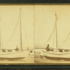 [A couple and their ketch-rigged sailboat, on dry land.]