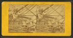 View of deck and masts of a whale ship on its side.