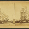 Wharves showing ships moored, barrels in foreground.