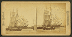 Wharves showing ships moored, barrels in foreground.