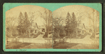 View of a large house, white picket fence in foreground.