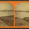 View of a lake, buildings on opposite shore.