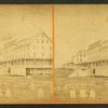 View of large beach houses, headstones in foreground.