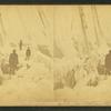 Winter scene showing ice men on the deck of a ship with ice covering the rigging.