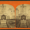 Interior view of Centerville with a map of the Holy Land visible on the wall above a lectern.