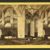 Interior view of the Baptist chapel showing seats and pews and the organ above the altar.