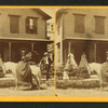 Miss Olive Jones sitting sidesaddle on her horse as others look on from the porch of a home.