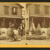 Miss Olive Jones sitting sidesaddle on her horse as others look on from the porch of a home.