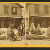 Miss Olive Jones sitting sidesaddle on her horse as others look on from the porch of a home.